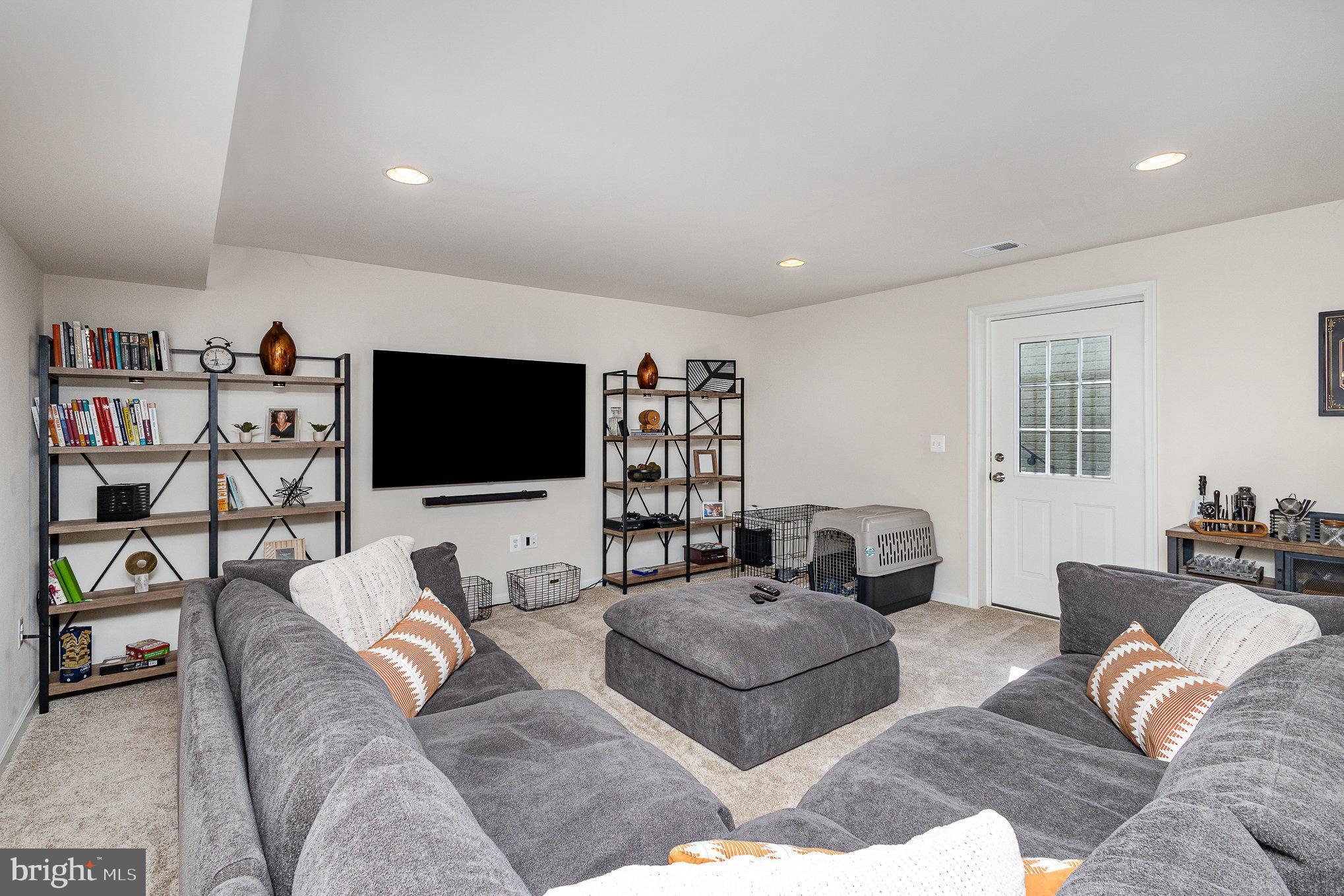 1040 Aspen Road Stafford, VA 22554 - Photo 41 of 51 a living room with furniture and a flat screen tv