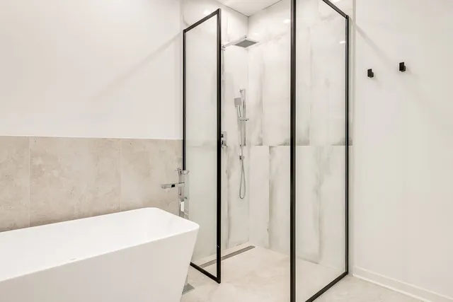 a bathroom with a bathtub and a shower