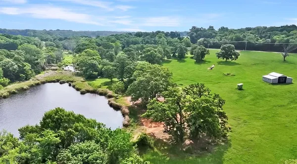a view of a lake with houses in back