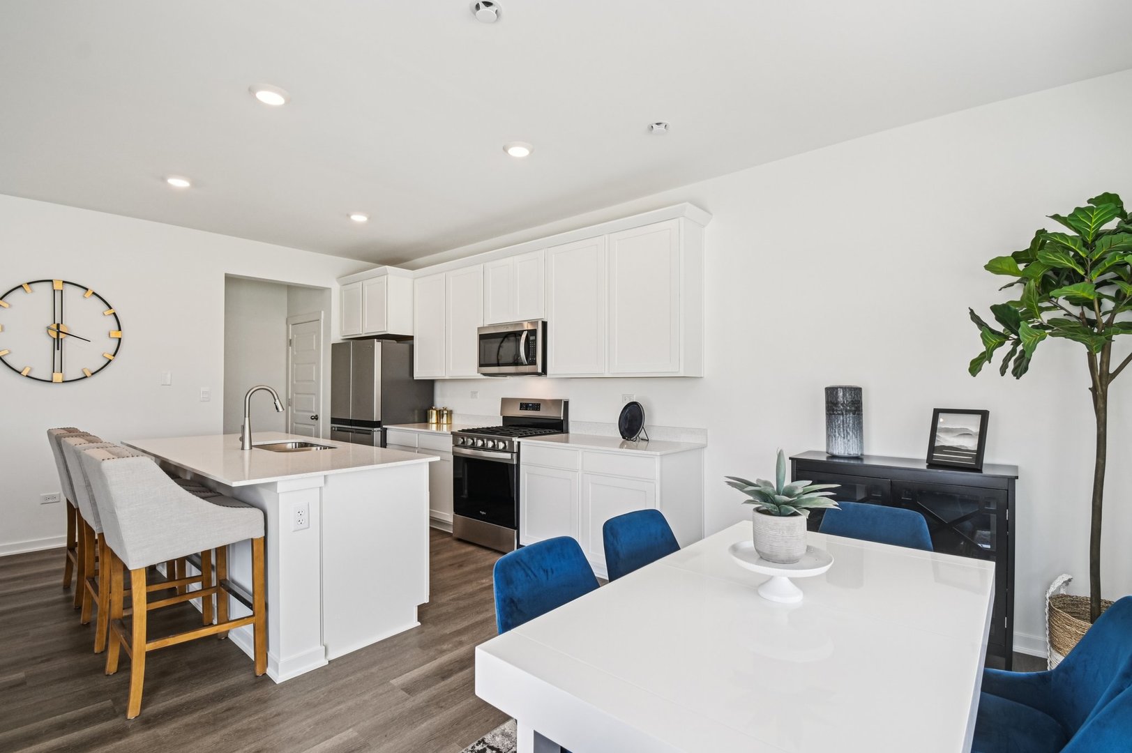 2417 Semillon Street Oswego, IL 60543 - Photo 12 of 45 a kitchen with stainless steel appliances kitchen island granite countertop a refrigerator a stove top oven a sink dishwasher and white appliances with wooden floor