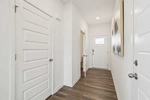 a view of a hallway with wooden floor
