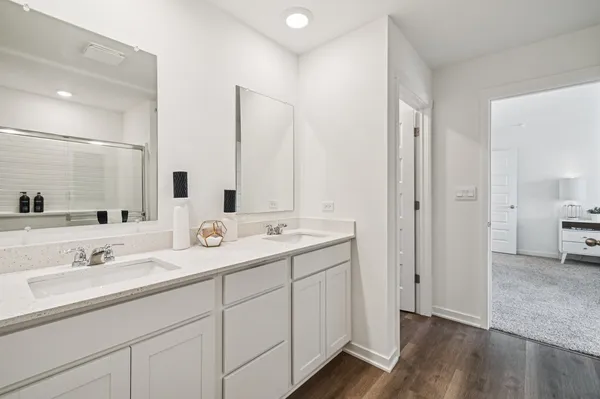 a bathroom with double sink and a mirror