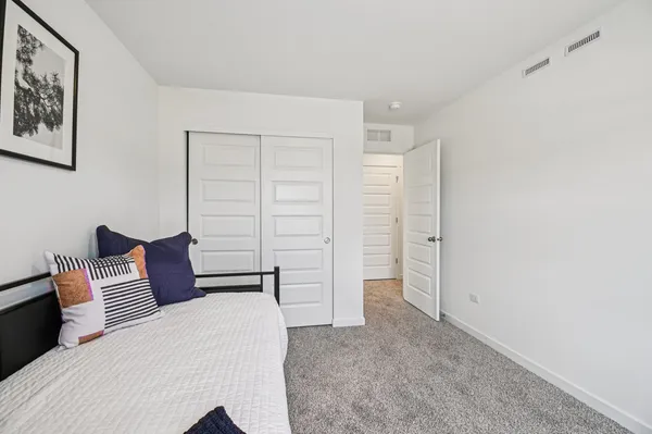 a bedroom with a bed and walk in closet