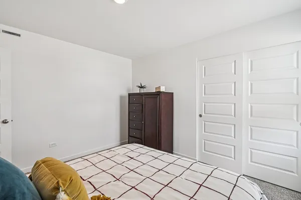 a bedroom with a bed and cabinets