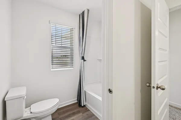 a white toilet sitting next to a small bathroom