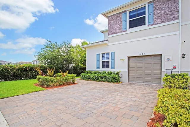a front view of a house with garden