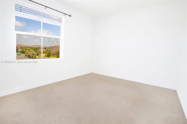 a view of a house with a yard and palm trees
