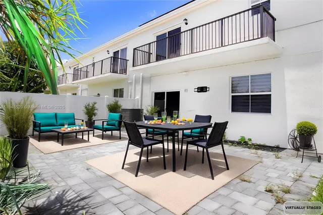 a kitchen with stainless steel appliances granite countertop a stove top oven a sink a refrigerator and white cabinets