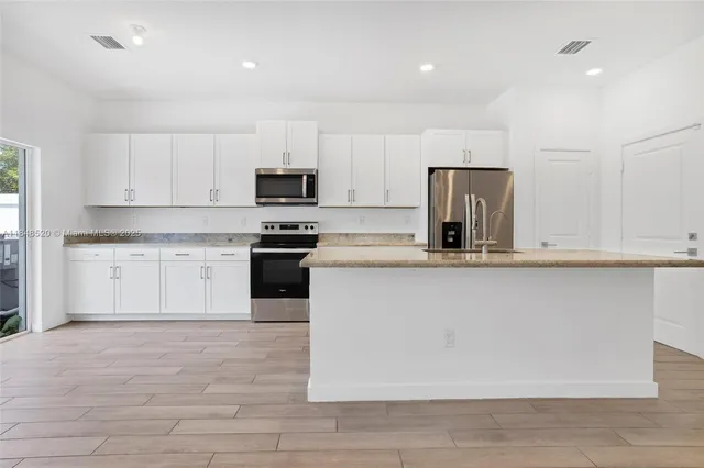 a front view of a house with a garden and yard