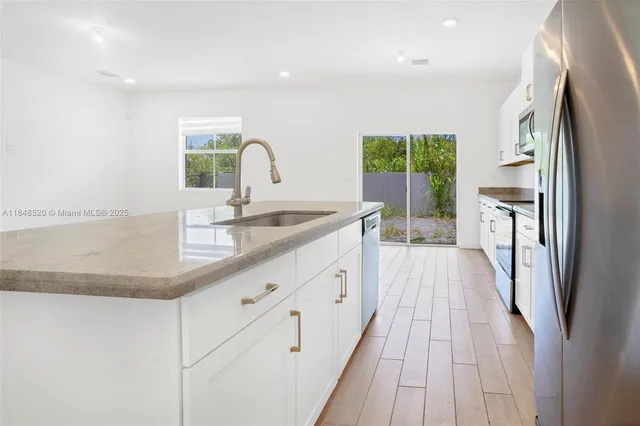 a kitchen with a sink and a refrigerator