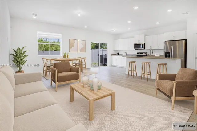 a living room with furniture kitchen and a table