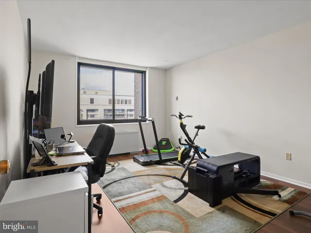 a room with gym equipment and a large window