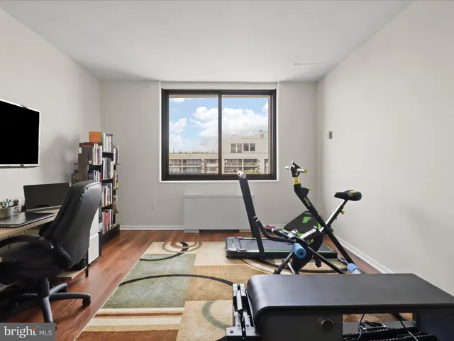 a work room with furniture and a flat screen tv