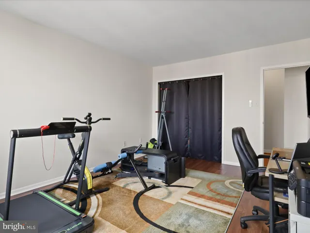a view of a workspace with furniture and a wooden floor