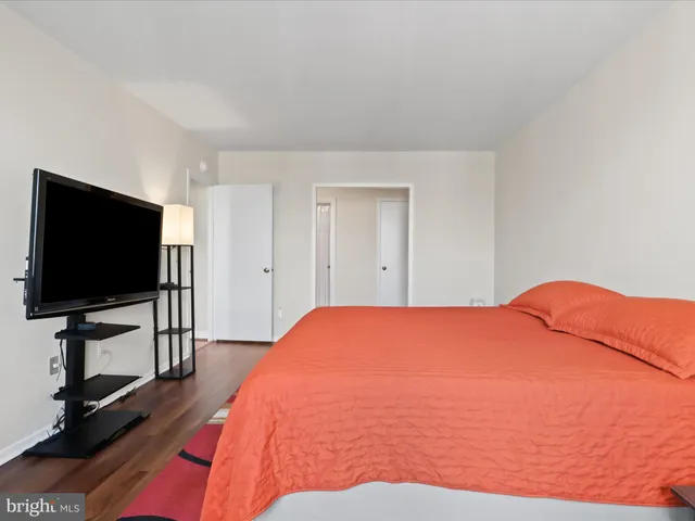 a bedroom with a bed and a flat screen tv