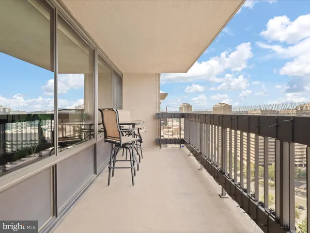 a balcony with table and chairs