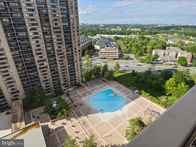 a view of swimming pool with outdoor seating and plants