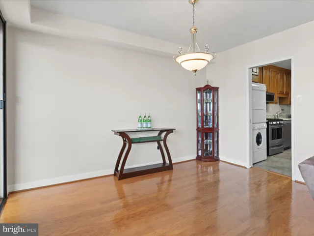 a view of a room with furniture and wooden floor