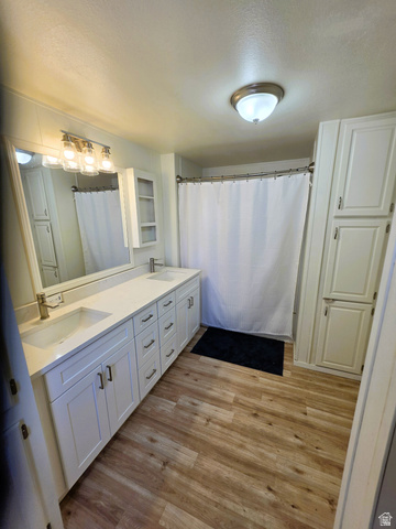 1604 180 East Tooele, UT 84074 - Photo 9 of 16 Primary Bathroom featuring a double vanity with white cabinetry, integrated sinks, and white quartz countertop.