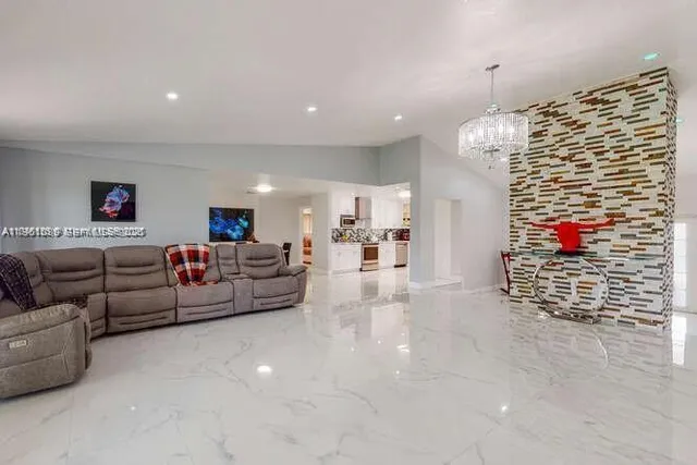 a living room with furniture and a chandelier