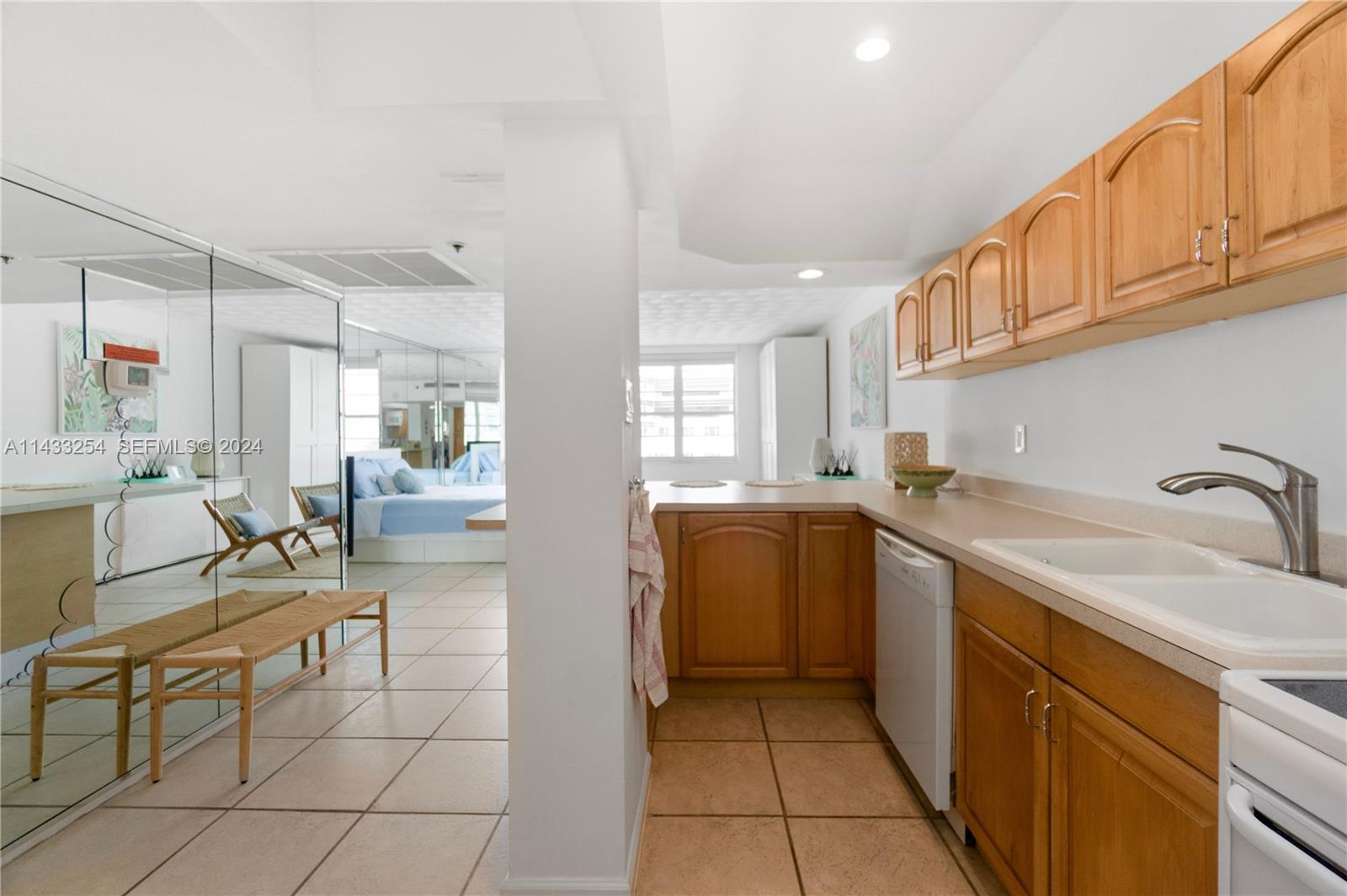 100 Lincoln Road, Unit 1039 Miami Beach, FL 33139 - Photo 14 of 26 a kitchen with sink cabinets and window