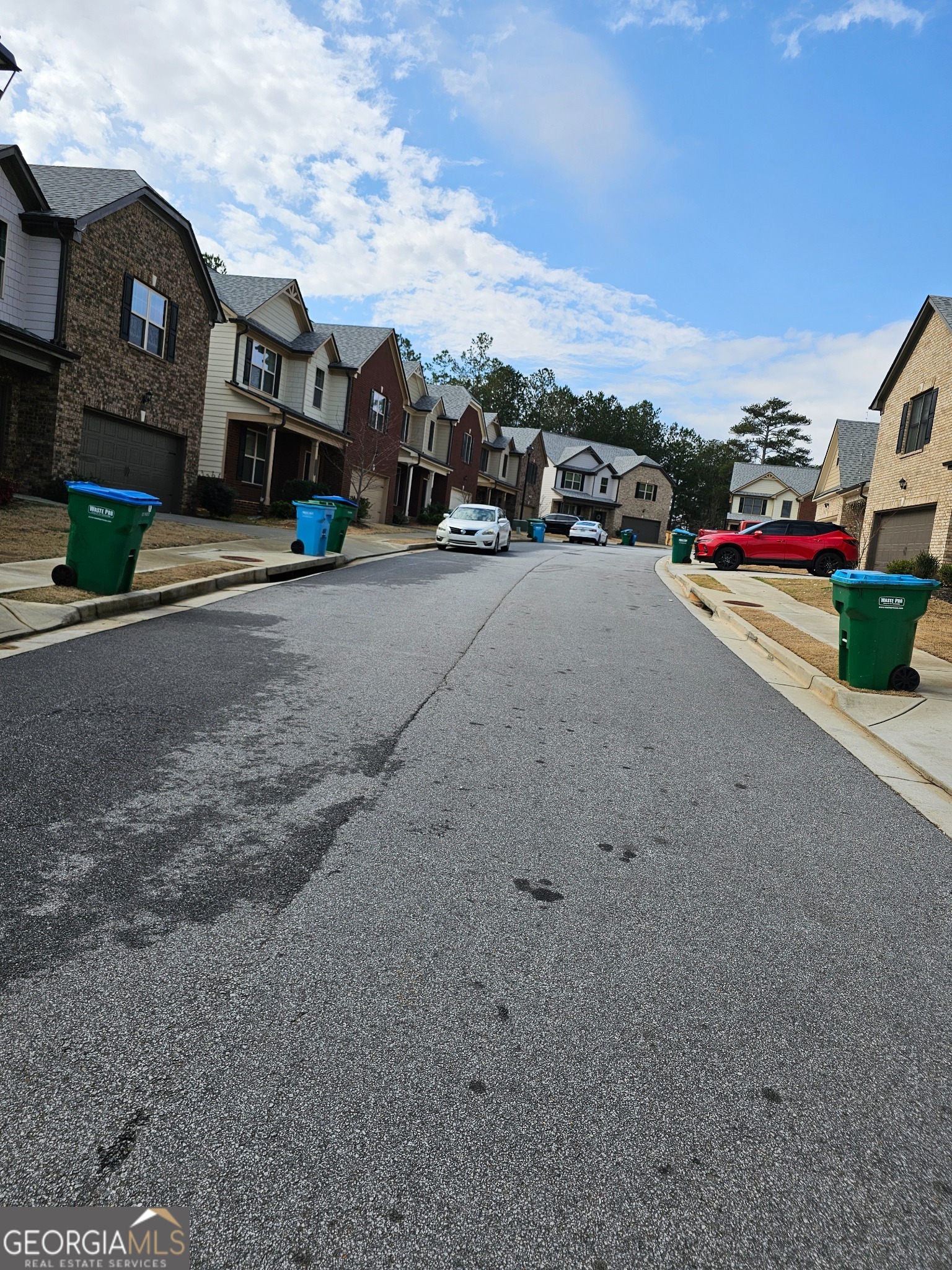 6509 Panasa Court Norcross, GA 30093 - Photo 16 of 16 a view of road with card parked on side and retail shops