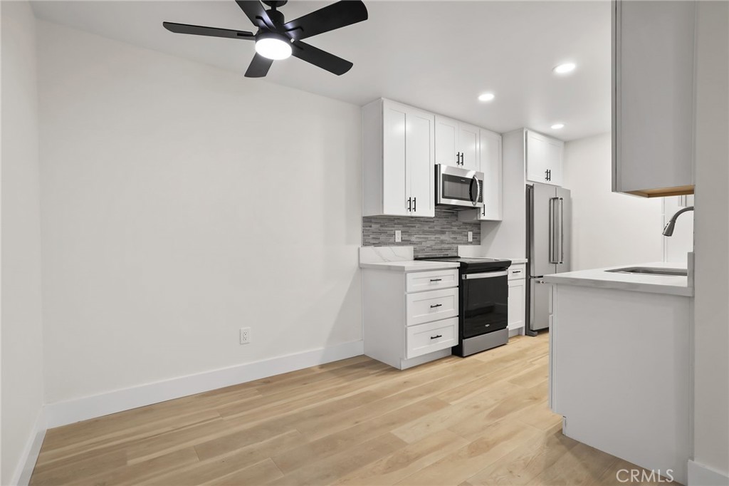 25611 Quail Run, Unit 63 Dana Point, CA 92629 - Photo 11 of 22 a kitchen with white cabinets and stainless steel appliances