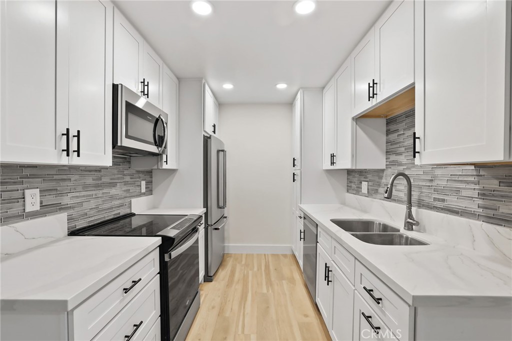 25611 Quail Run, Unit 63 Dana Point, CA 92629 - Photo 14 of 22 a kitchen with stainless steel appliances granite countertop a sink stove and refrigerator