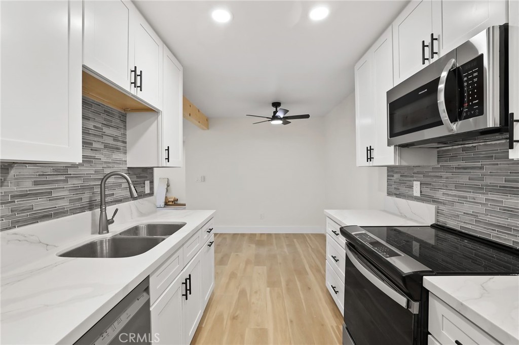 25611 Quail Run, Unit 63 Dana Point, CA 92629 - Photo 15 of 22 a kitchen with a sink stove and microwave