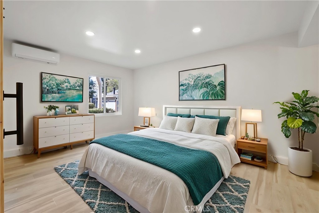 25611 Quail Run, Unit 63 Dana Point, CA 92629 - Photo 5 of 22 a spacious bedroom with a bed a couch and paintings on the wall
