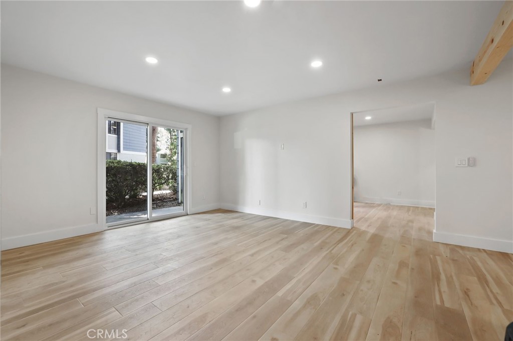 25611 Quail Run, Unit 63 Dana Point, CA 92629 - Photo 7 of 22 a view of an empty room with wooden floor and a window