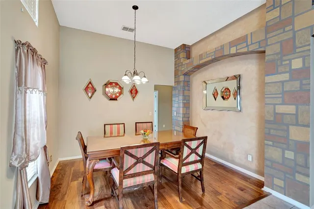 a dining room with a wooden table and chairs