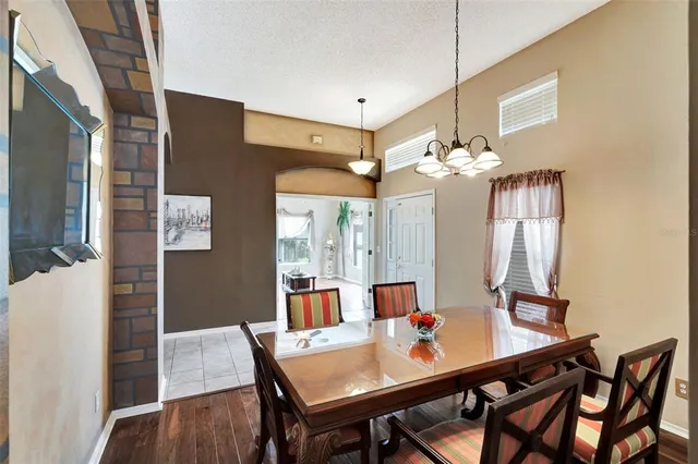 a view of a dining room with furniture and a chandelier