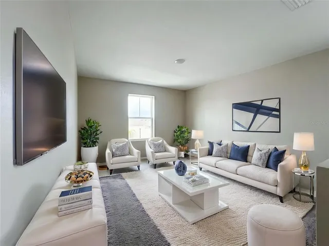 a living room with furniture and a large window