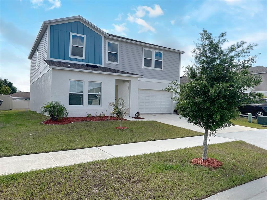 1404 Axel Circle Winter Haven, FL 33880 - Photo 2 of 21 a front view of a house with garden