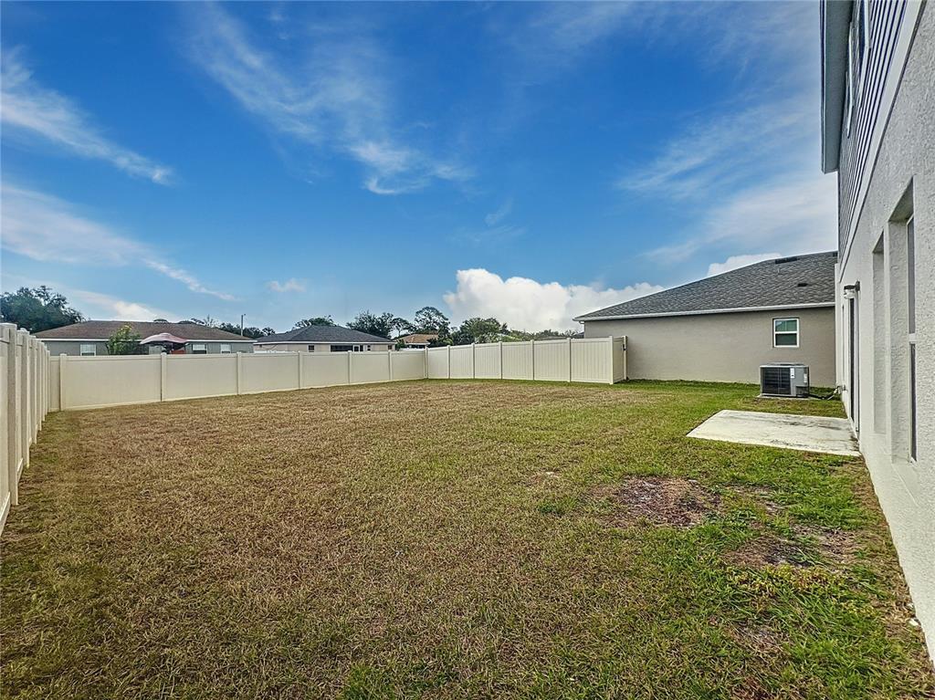 1404 Axel Circle Winter Haven, FL 33880 - Photo 21 of 21 a view of a house with a yard and a large tree