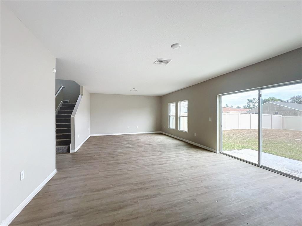 1404 Axel Circle Winter Haven, FL 33880 - Photo 4 of 21 a view of empty room with wooden floor and fan
