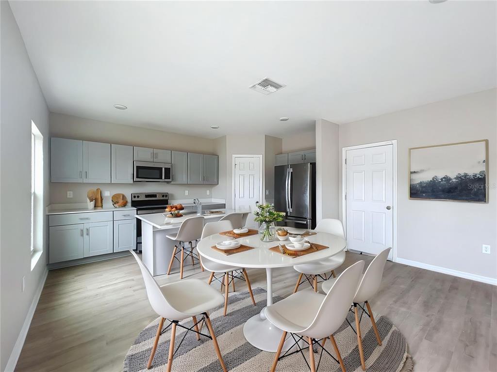 1404 Axel Circle Winter Haven, FL 33880 - Photo 5 of 21 a kitchen with a dining table chairs and wooden floor