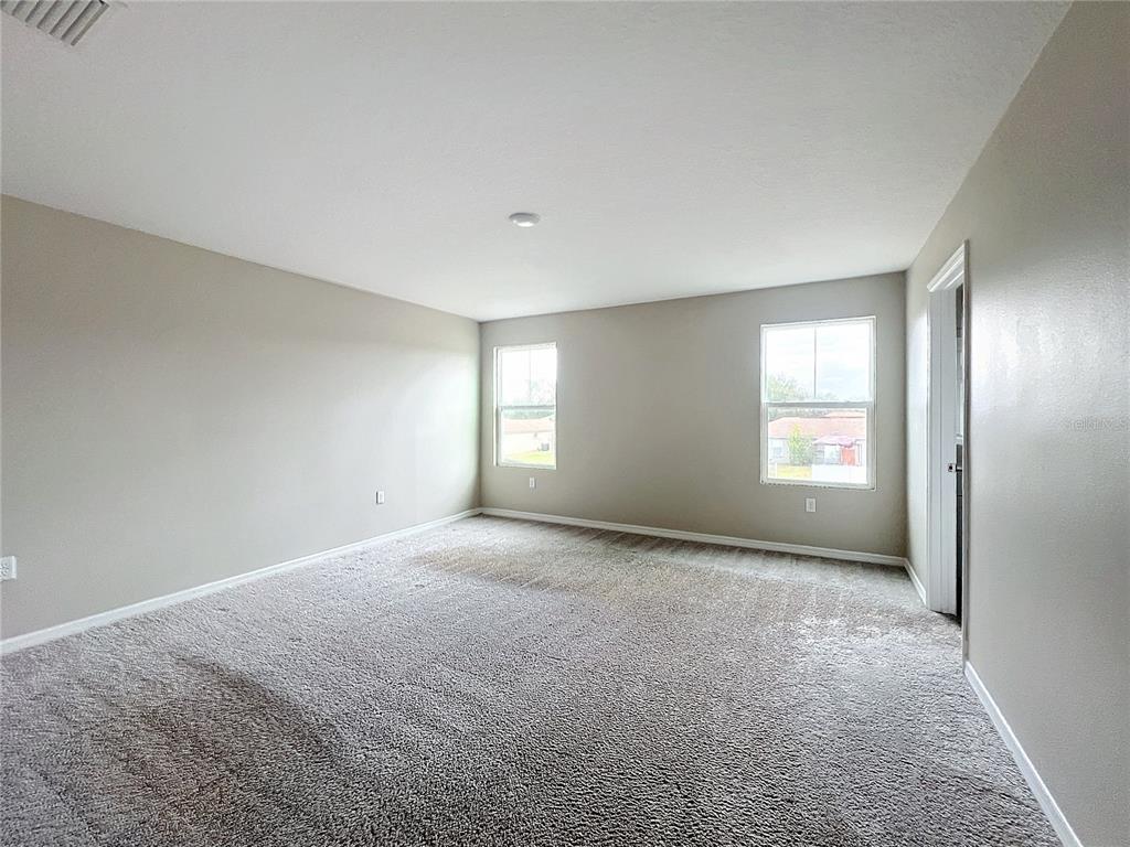 1404 Axel Circle Winter Haven, FL 33880 - Photo 8 of 21 a view of a big room with windows and chandelier fan