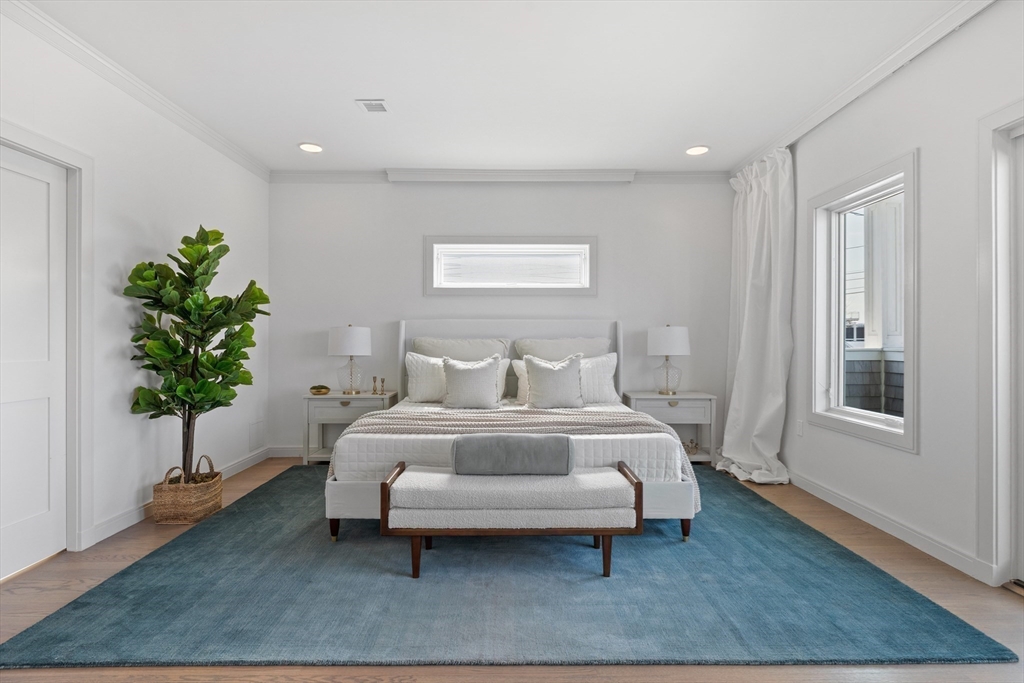 137 Wessagussett Road Weymouth, MA 02191 - Photo 15 of 32 a spacious bedroom with a bed and a potted plant