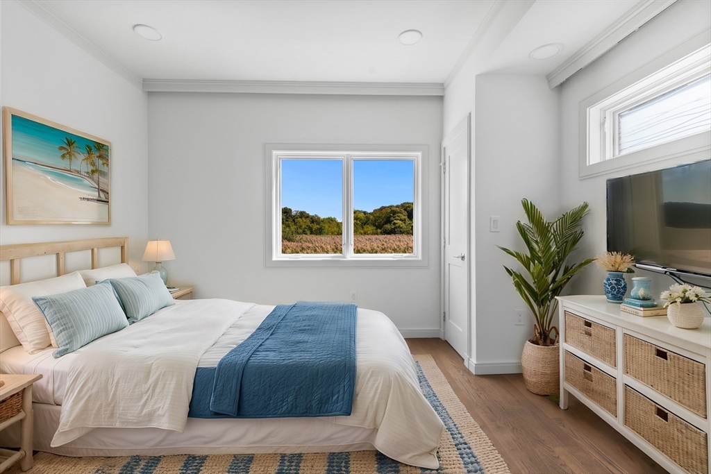 137 Wessagussett Road Weymouth, MA 02191 - Photo 20 of 32 a bedroom with a bed and a flat screen tv