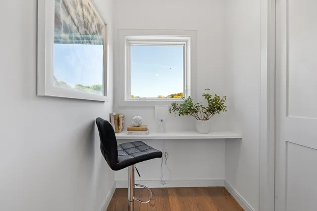 a living room with furniture hard wood floor and a table