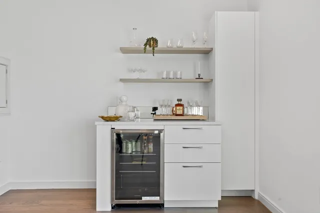 a spacious bedroom with a bed and a potted plant