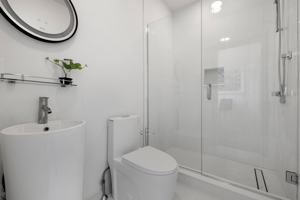 137 Wessagussett Road Weymouth, MA 02191 - Photo 10 of 32 a bathroom with a toilet sink and shower