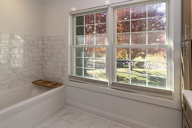 936 Chase Court Gurnee, IL 60031 - Photo 8 of 15 a bathroom with a bathtub and next to a window