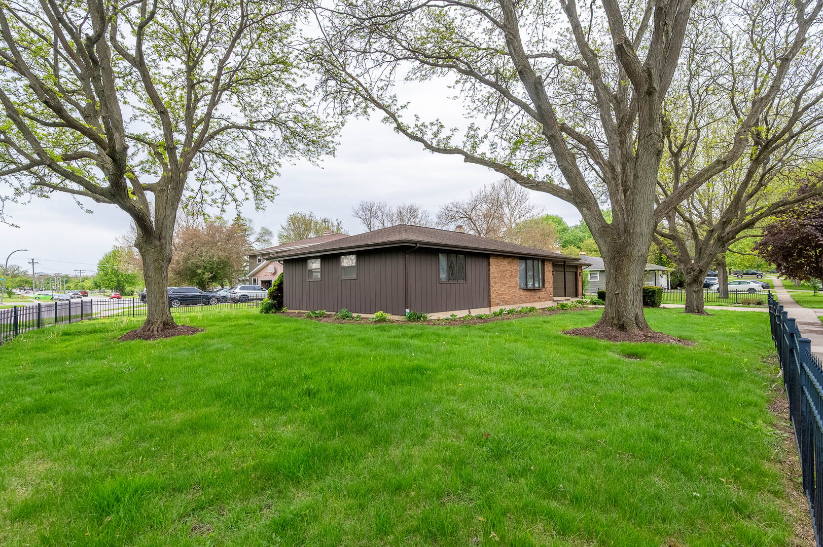 765 Algona Avenue Elgin, IL 60120 - Photo 13 of 13 a view of a house with a big yard large tree and a large tree