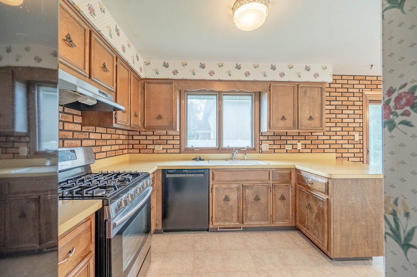 765 Algona Avenue Elgin, IL 60120 - Photo 5 of 13 a kitchen with granite countertop a sink stove and cabinets