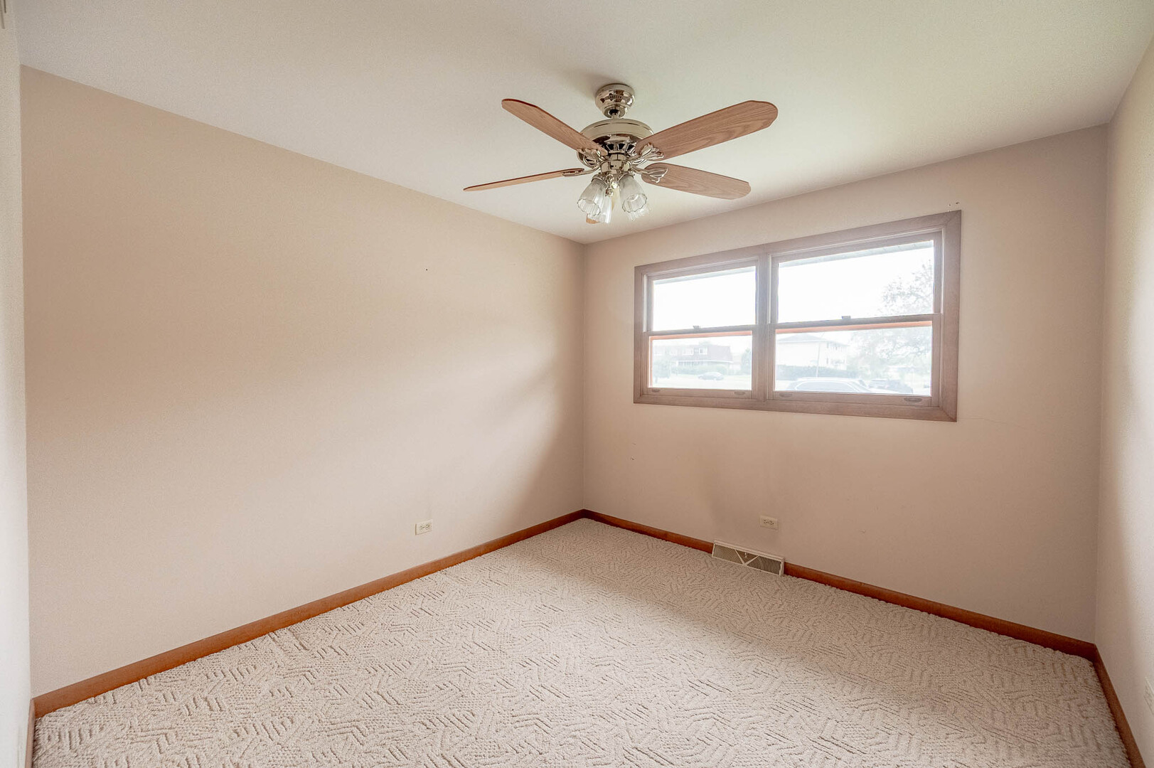 765 Algona Avenue Elgin, IL 60120 - Photo 7 of 13 an empty room with a window and a fan