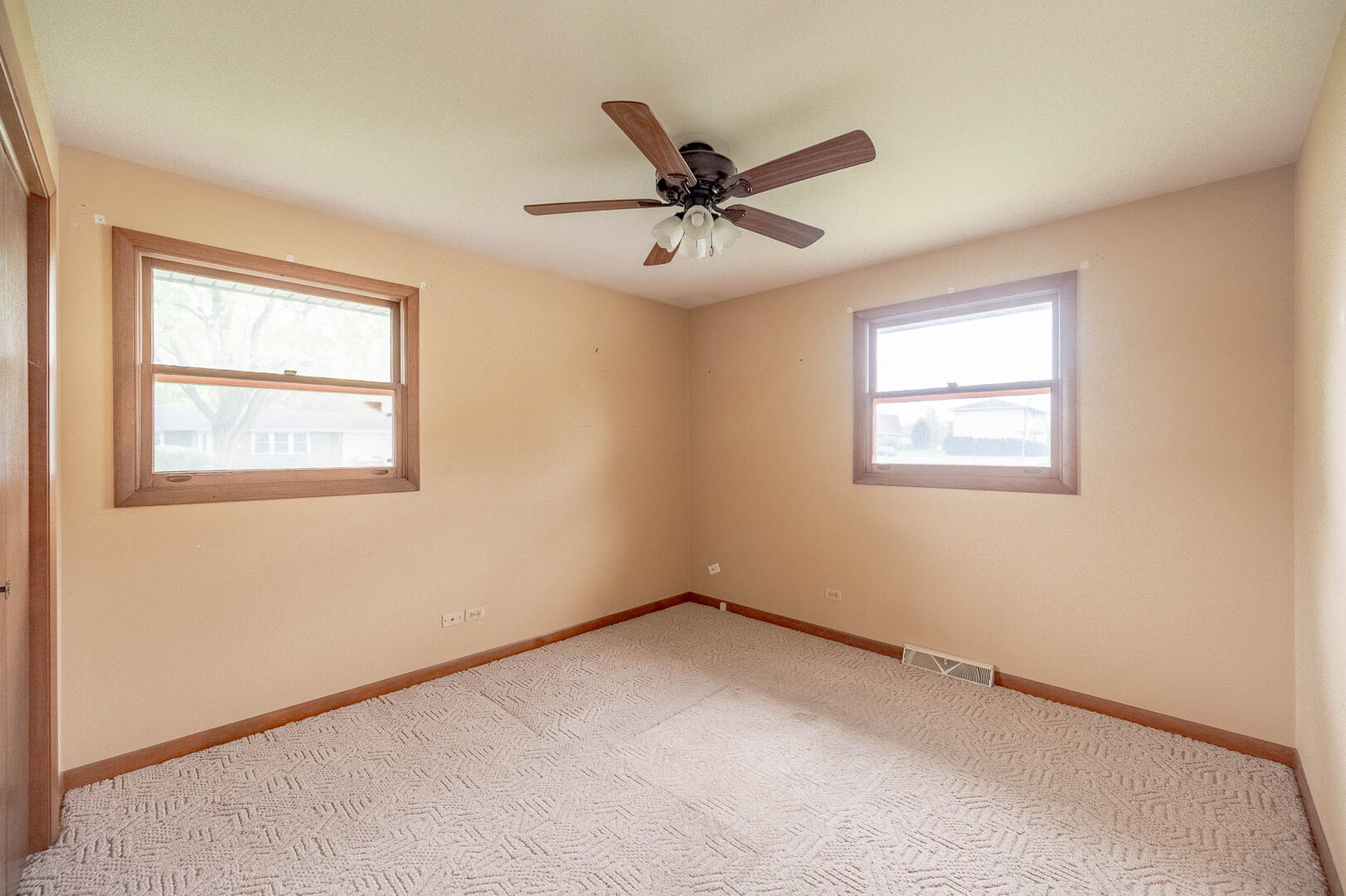765 Algona Avenue Elgin, IL 60120 - Photo 8 of 13 an empty room with a window and a fan