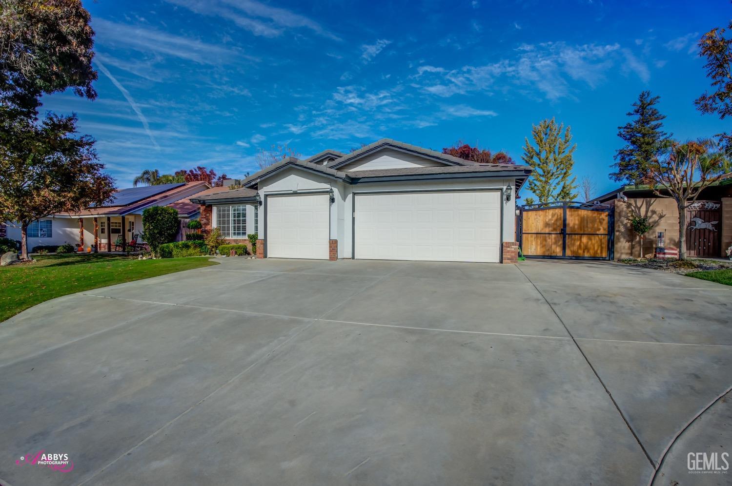a view of house with outdoor space and tree in front of it